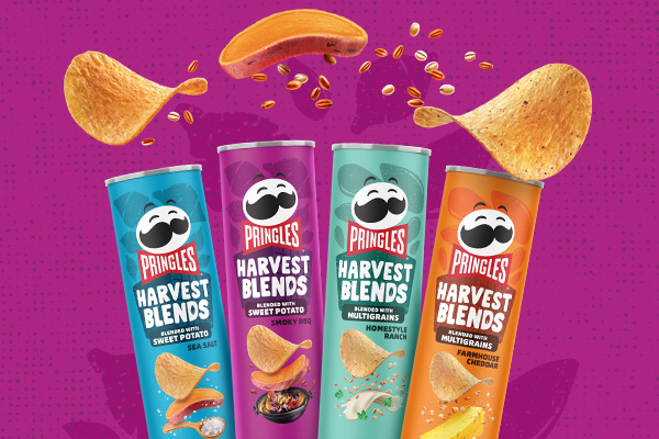 Pringles Harvest Blend with sweet potato product cans, sea salt flavor, smoky bbq flavor, homestyle ranch flavor, and farmhouse cheddar flavor, with individual pringles crisps above them on a purple background