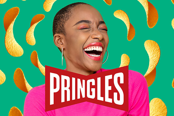 A smiling woman surrounded by Pringles chips.